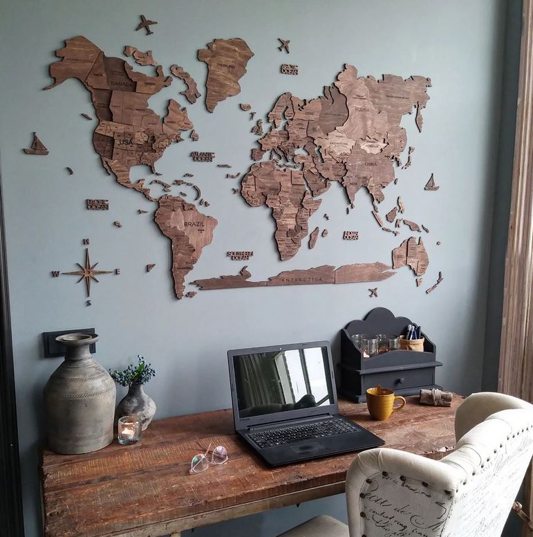 A 3D Wooden World Map in a Home Office on a light blue wall