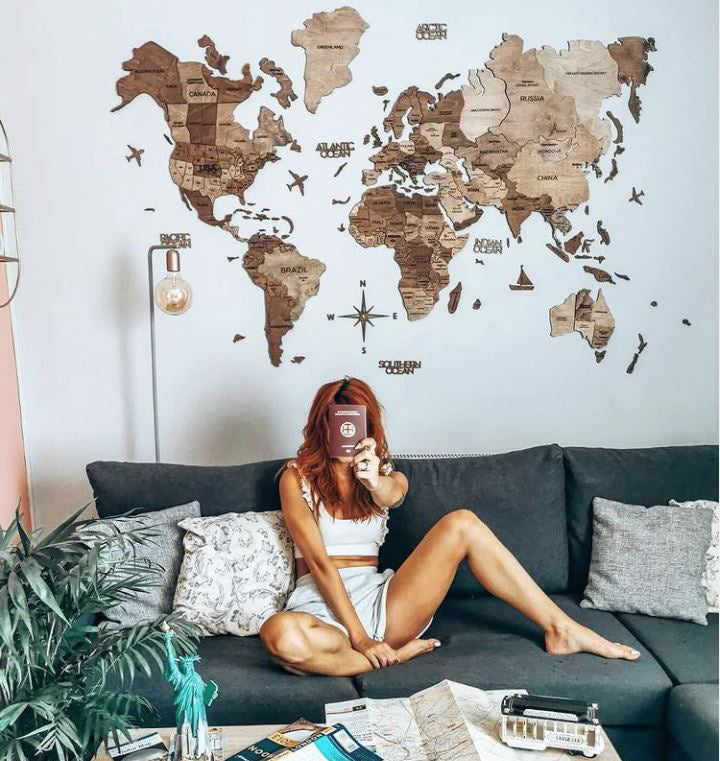 3D Wooden World Map in Terra Color with a Woman showing her Passport