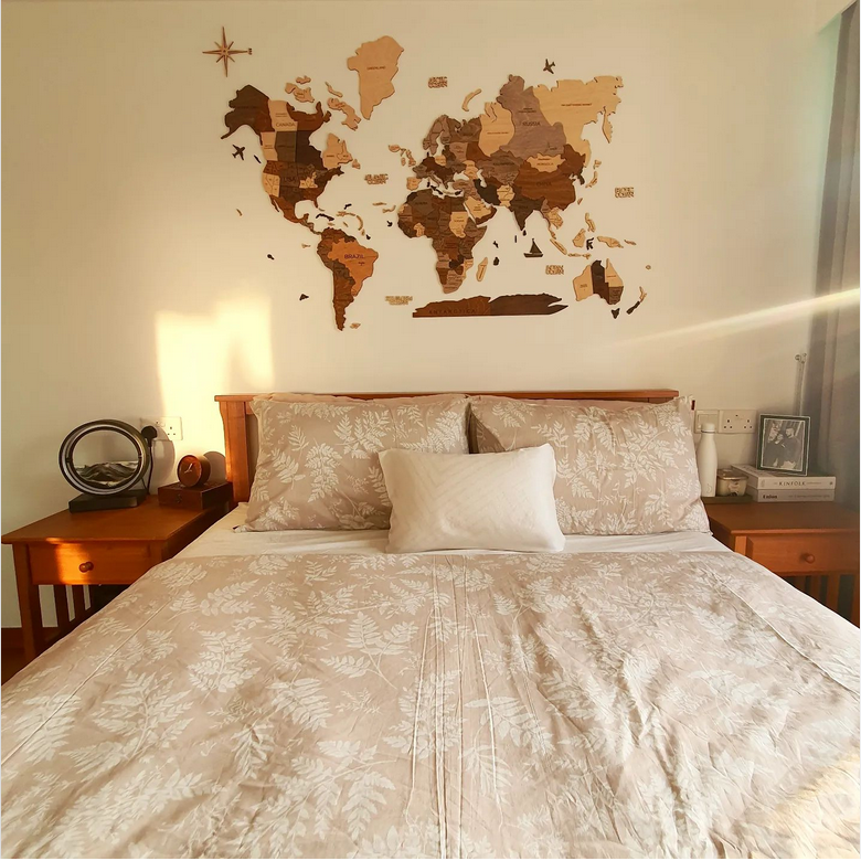 3D Wooden World Map in Multicolor over a Bed
