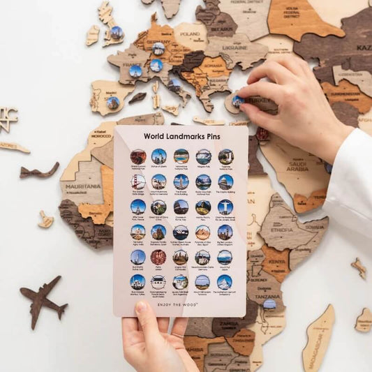 Landmark Pins on a Wooden World Map