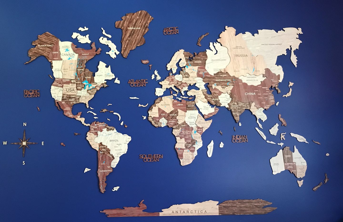 3D Wooden World Map in Cappuccino Color on a Blue Wall