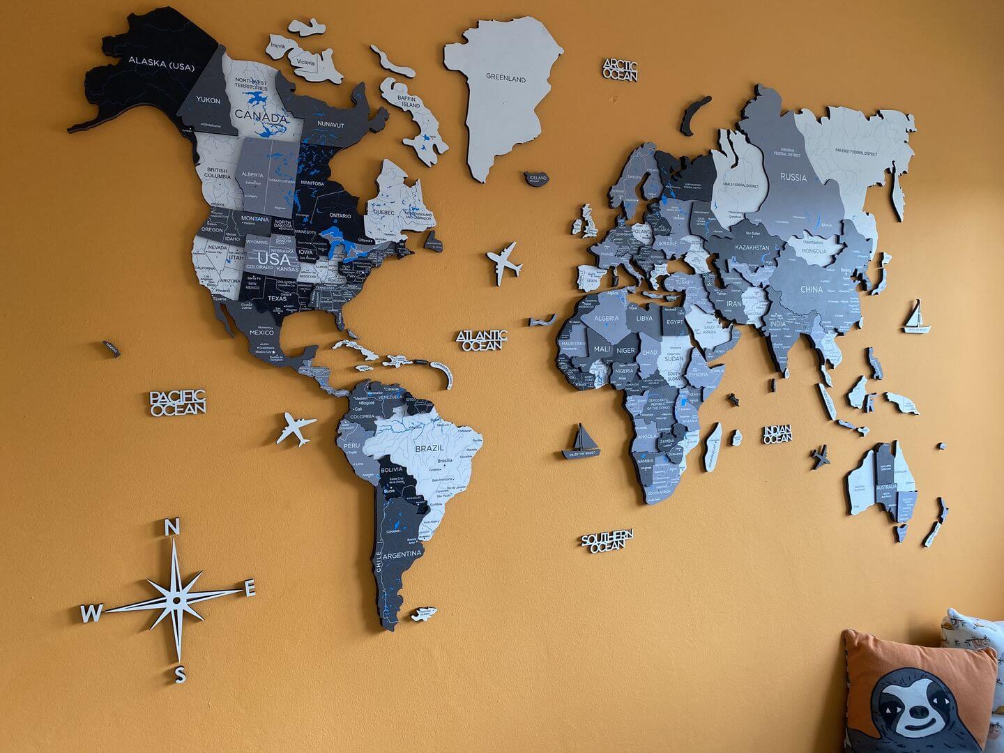 A 3D Wooden World Map in color Nordik on an Orange Wall
